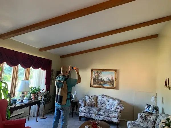 Inspector reviewing a home exterior on a tablet